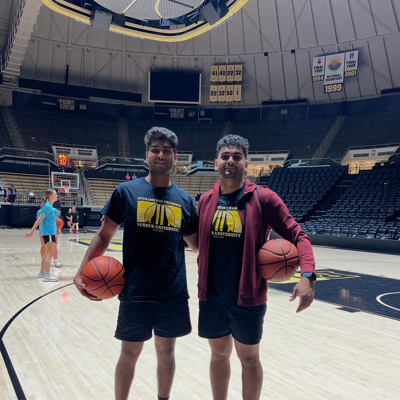 Akshat holding a basketball at Purdue's Mackey Arena.