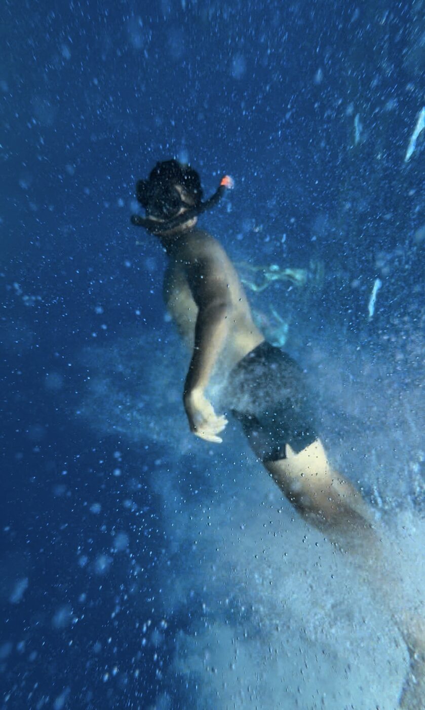 Akshat snorkeling underwater.